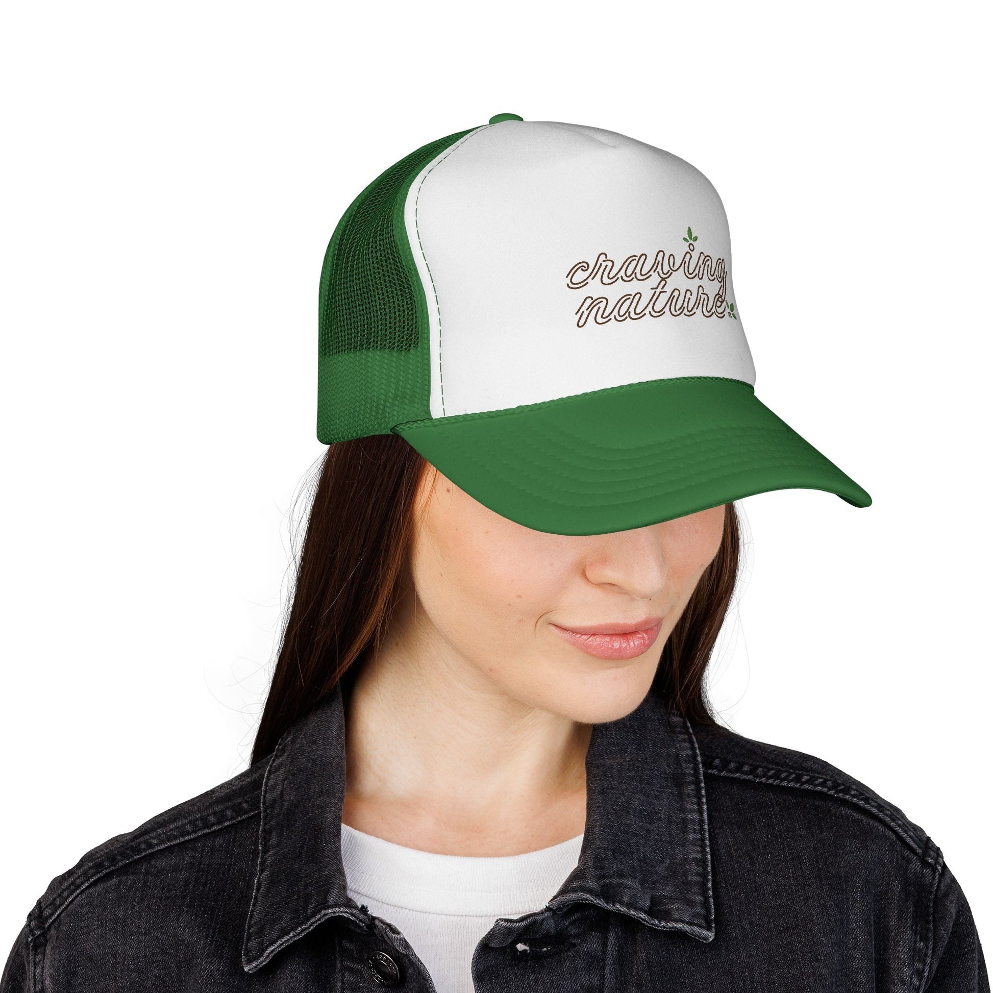 Model showing right side of Retro Trucker Cap, with green bill & mesh in back. White front with 'craving nature' design.